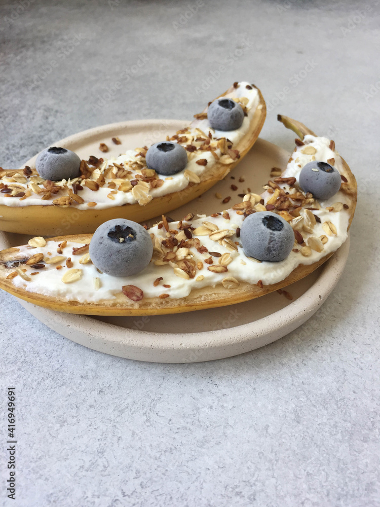 bananas and blueberries with granola on a plate bananas and blueberries with granola on a plate