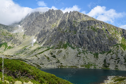 Beautiful mountain lake Batizovske Pleso, surrounding peaks and the highest peak of High Tatras mountains, Gerlachovsky stit. Slovakia