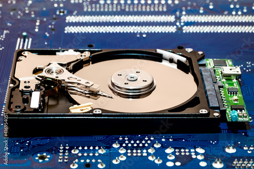 Close-up of a hard drive on a blue printed circuit board