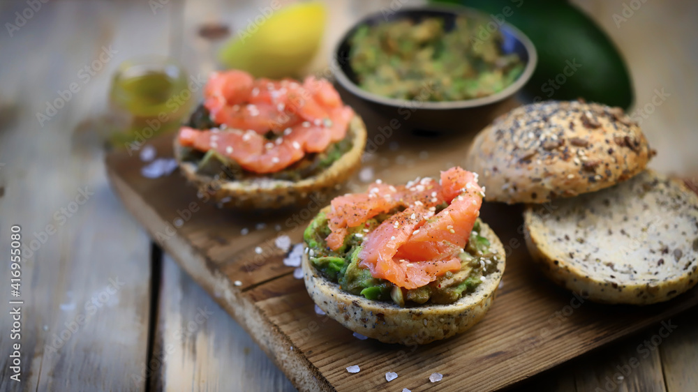 Selective focus. Delicious burgers with salmon and guacamole. Keto food. Healthy diet.