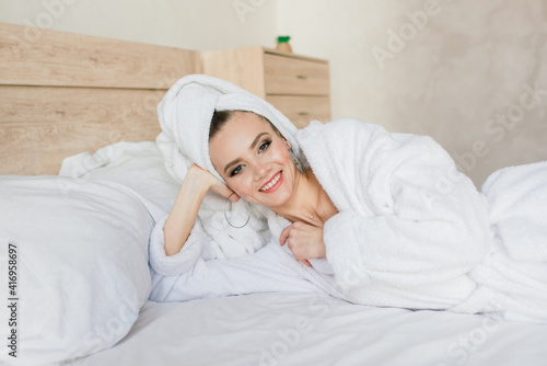 Beautiful young healthy woman relaxing in a robe, hotes, room, spa salon