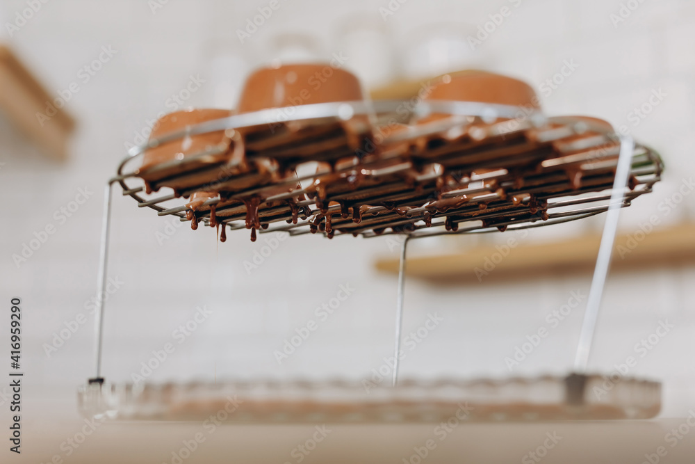 Baker decorating dessert, by filling chocolate on it. Baker decorating dessert, by filling chocolate on it.