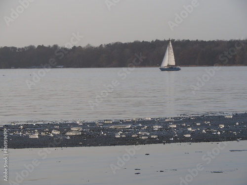 Ice on water with sailing boat