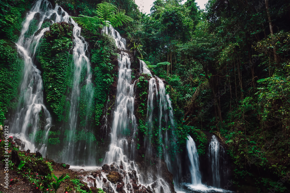Fototapeta premium Cascade waterfall in jungle in Indonesia