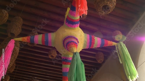 Colorful pinata and handmade lamps hanging from the ceiling