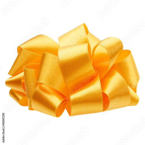 Shiny satin round ribbon bow in yellow color isolated on white background close up