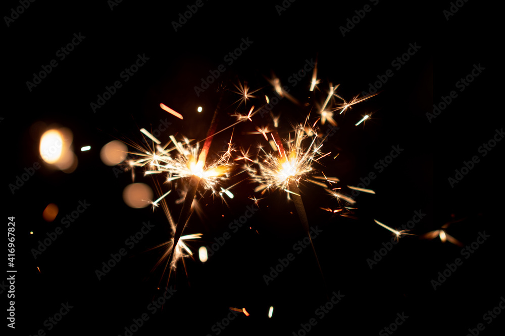 Burning two sparklers, abstract blur background. Burning two sparklers, abstract blur background.