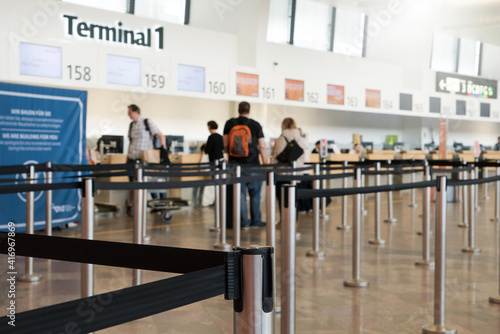 Close up of check-in area with belt control queue at international airport Vienna Austria. Queue barrier for waiting.