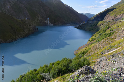 Panorama of the Zaramag reservoirs in the mountains of the North Caucasus on a hot summer day. Republic of North Ossetia - Alania