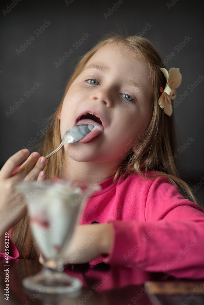 Beautiful girl in a cafe eats ice cream, close-up. Beautiful girl in a cafe eats ice cream, close-up.