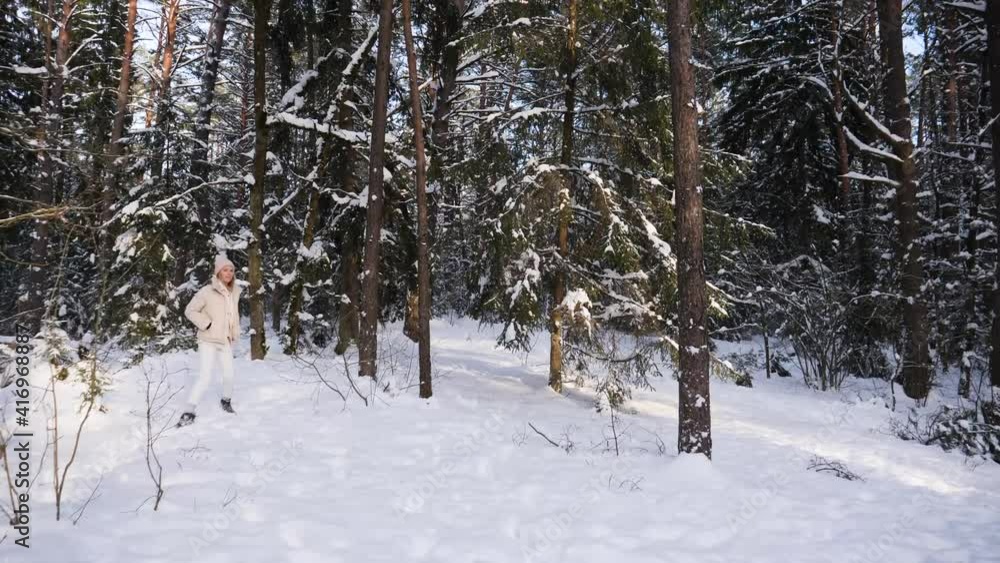 Female walk in winter forest and turn around to look. Female walk in winter forest and turn around to look.