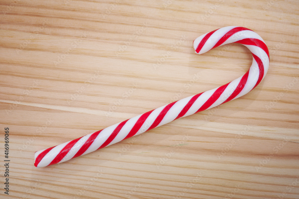 Candy cane on wooden background Candy cane on wooden background