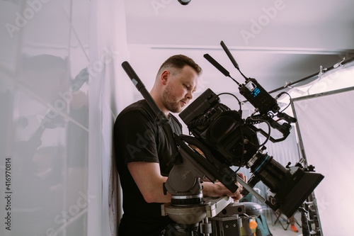 Director of photography with a camera in his hands on the set. © Anna