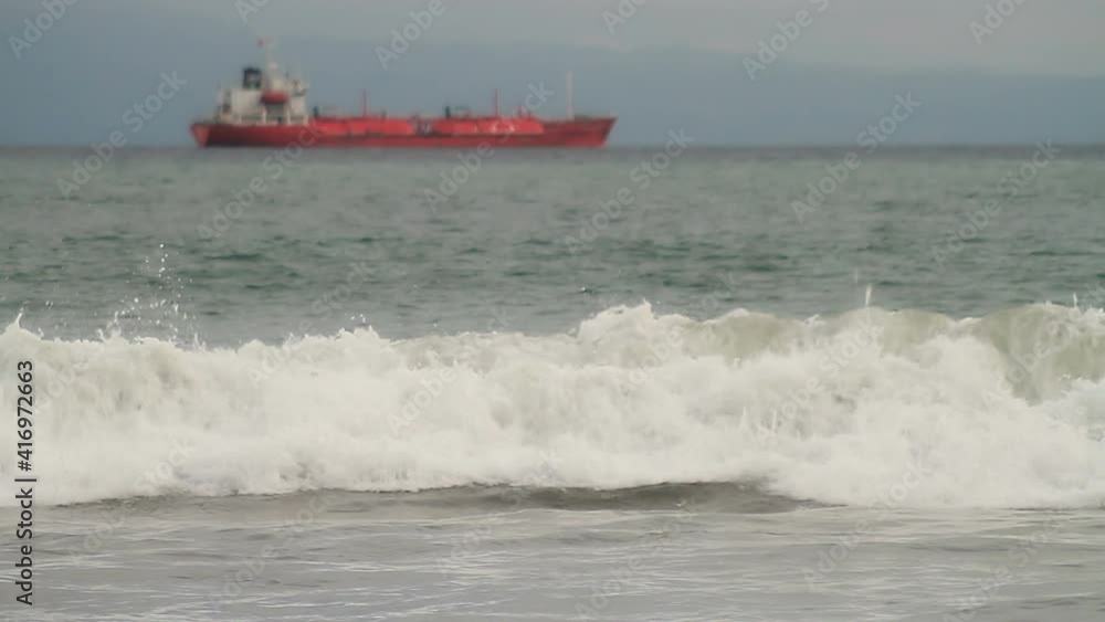 Cargo ship tanker against gray sky and dramatic sea Cargo ship tanker against gray sky and dramatic sea