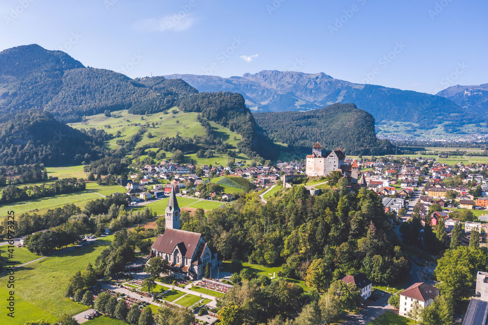 Burg Gutenberg, intact medieval castle and a church on a hilltop. Balzers, Liechtenstein
