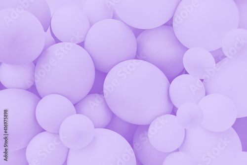 Lavender balloons background, punchy pastel violet colored and soft focus. Party festive balloons photo wall birthday decoration for children. Background for wedding, anniversary, birthday.