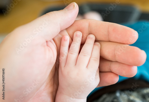 Parent holding little baby hand © Jasmin Merdan