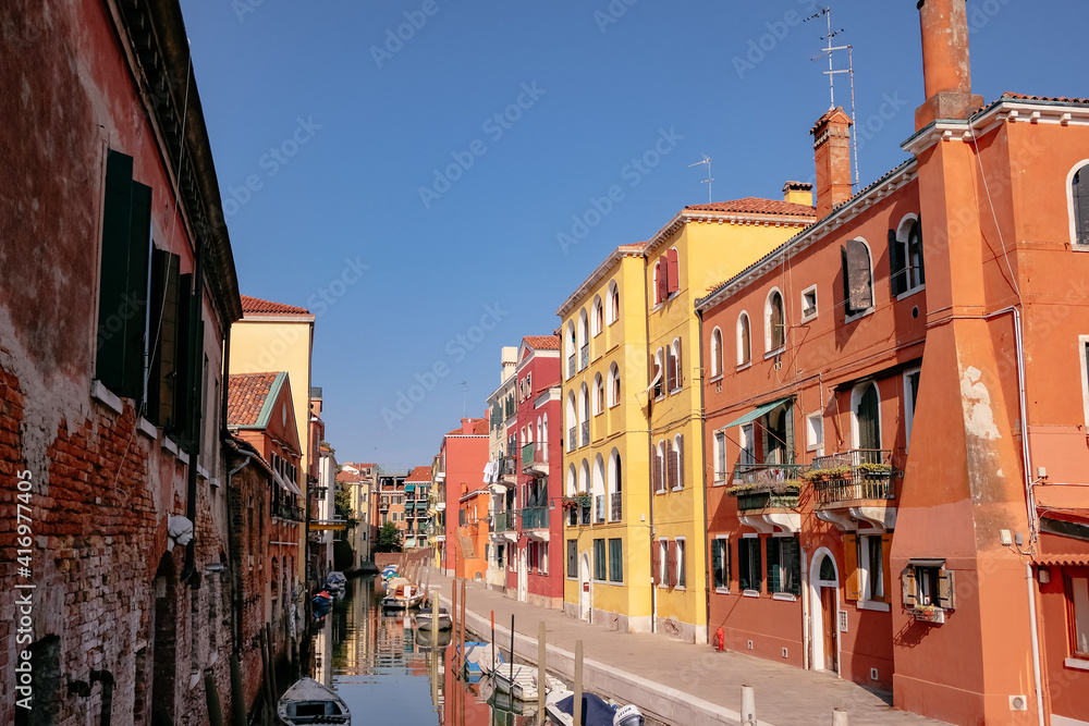 Fototapeta Colorful Traditional Venetian Houses in a canal with moored boats in Cannaregio - Quiet Morning with Empty Streets in Venice, Veneto, Italy