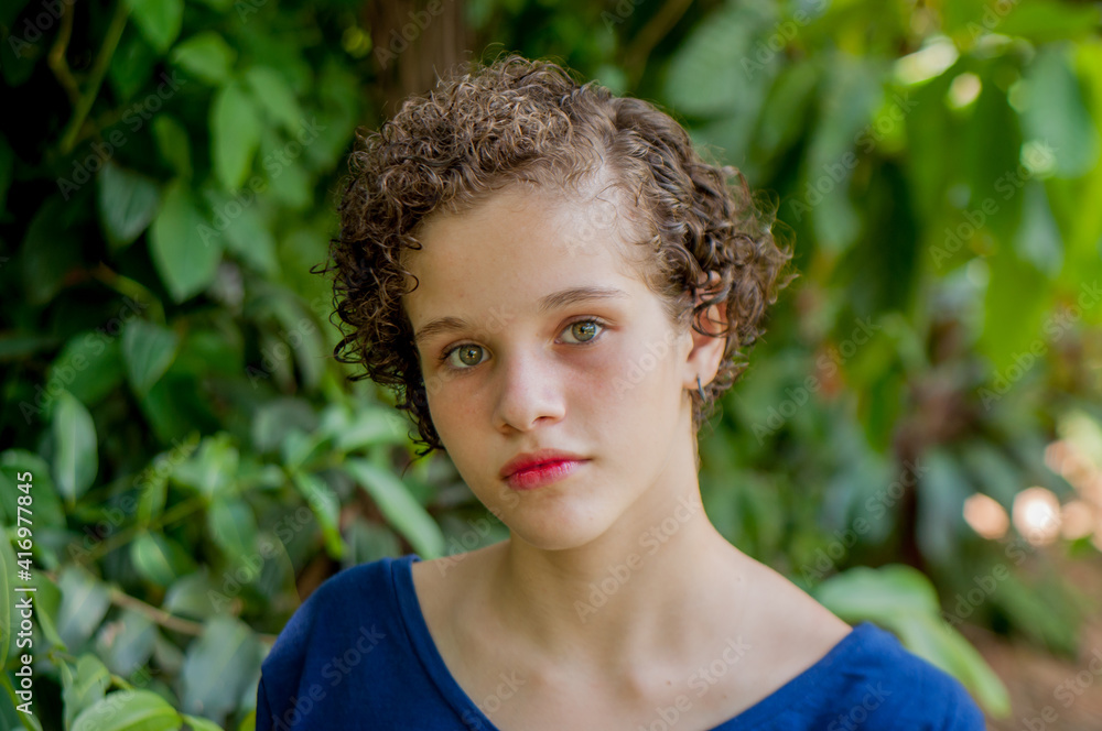Portrait of young lady with short curly hair looking at camera Portrait of young lady with short curly hair looking at camera