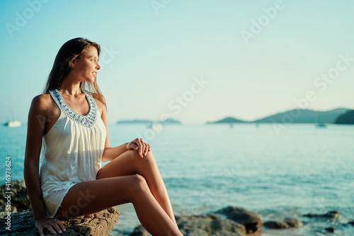 Outdoor portrait of young beautiful woman with long hair on the sea beach. © luengo_ua