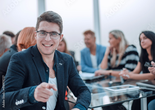 Handsome smiling business man wearing eyeglasses sitting in the