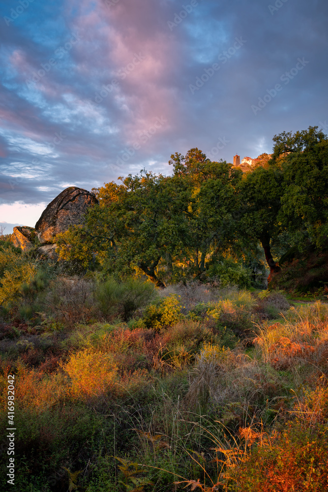 Monsanto historic stone village at sunset with red and yellow landscape, in Portugal