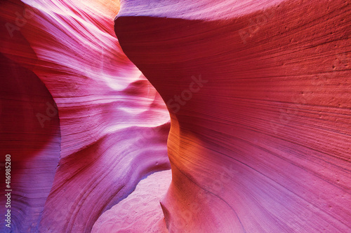 Beautiful red and orange sandstone wall with warm subtle light glow inside Antelope Canyon, Arizona, America