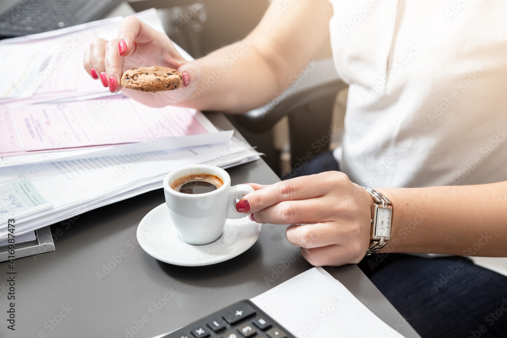 Business woman about to drink morning coffee in the office at her desk Business woman about to drink morning coffee in the office at her desk