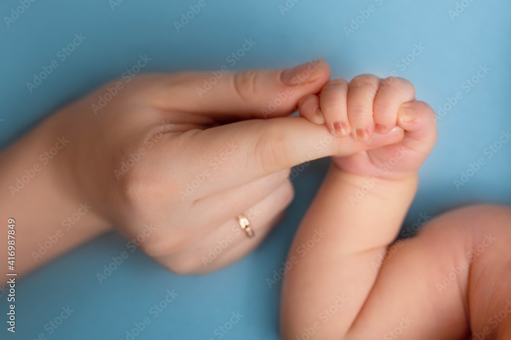 newborn baby holds mom's finger. hand of a newborn baby newborn baby holds mom's finger. hand of a newborn baby