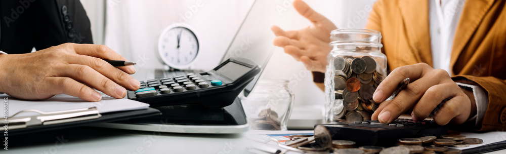 Healthcare costs and fees concept.Hand of smart doctor used a calculator for medical costs in modern hospital Healthcare costs and fees concept.Hand of smart doctor used a calculator for medical costs in modern hospital