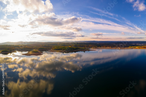 Drone aerial view of a lake reservoir of a dam with perfect reflection on the water of the sky in Sabugal  Portugal