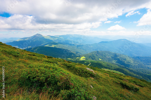 hoverla peak of carpathian black ridge. beautiful summer landscape at noon. clouds on the sky above the valley. view from petros mountain slope covered in grass