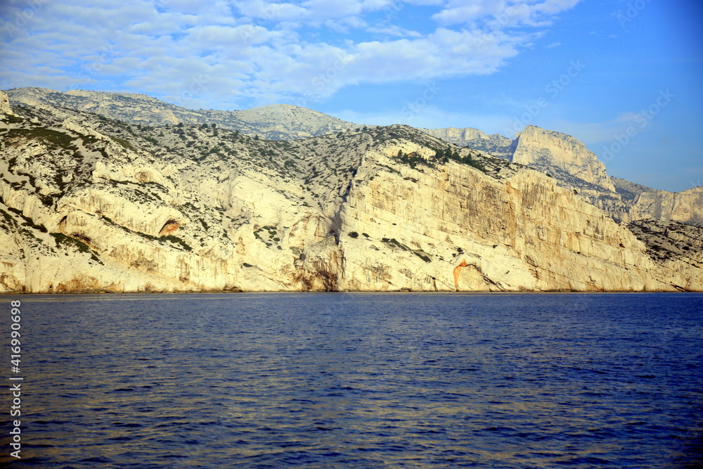 Front view of the fractured rock face, overlooking the blue sea, Parc National des Calanques, Marseille, France