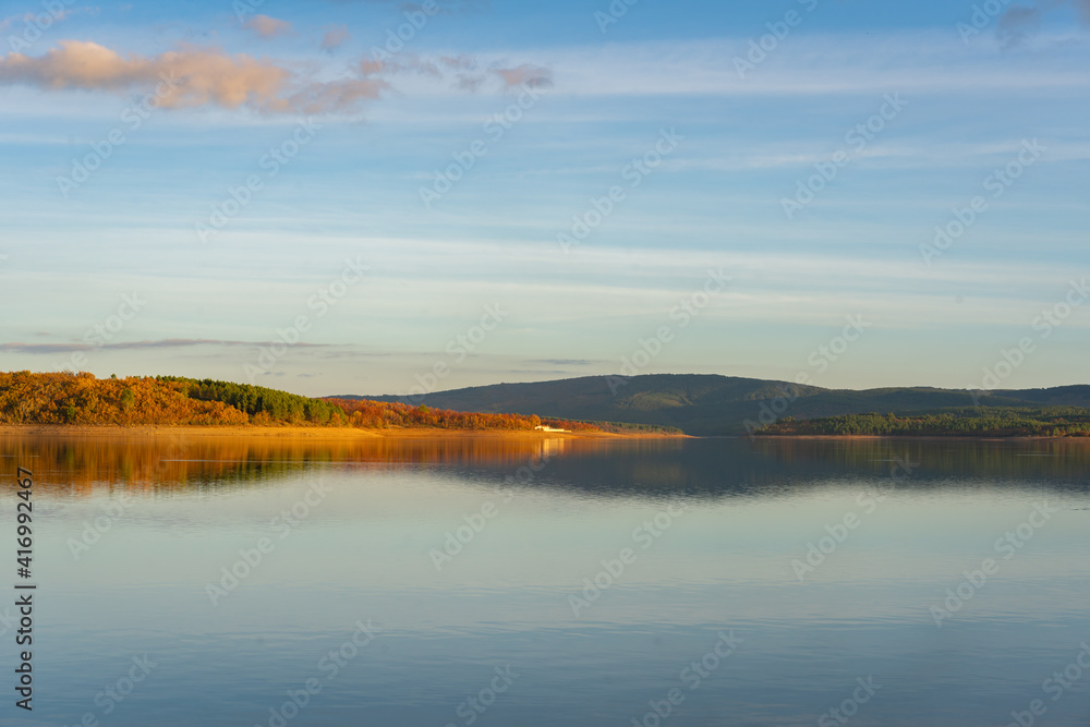 Lake reservoir dam landscape view at sunset during autumn fall in Sabugal Dam, Portugal