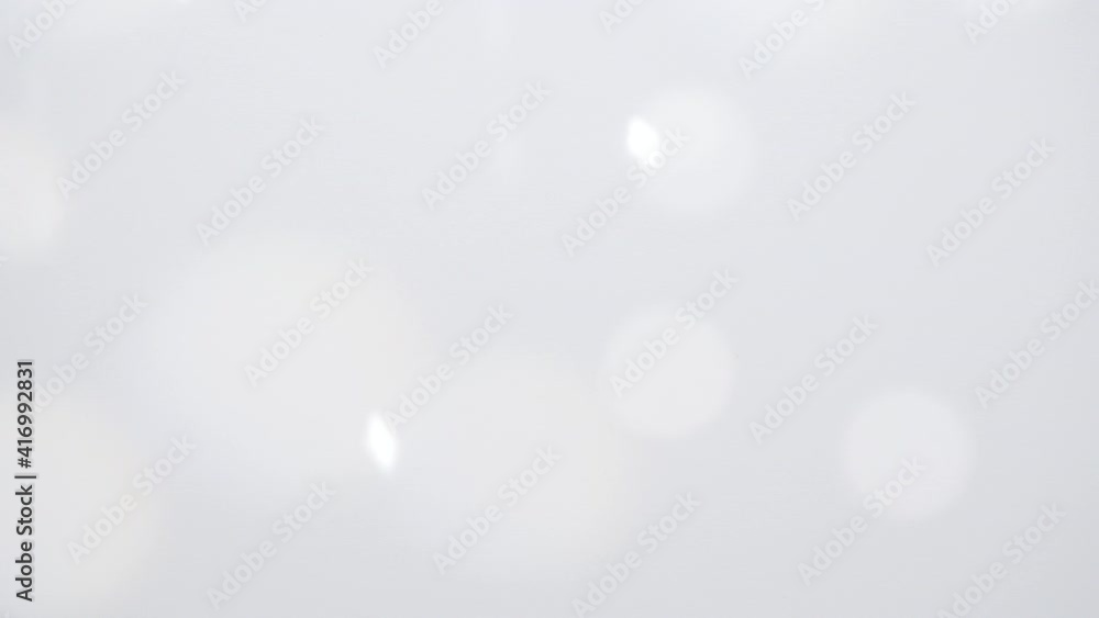 Shadow overlay blurred background. Sun rays, glare and effects on a white wall. Sunlight effect on white light wall background Shadow overlay blurred background. Sun rays, glare and effects on a white wall. Sunlight effect on white light wall background