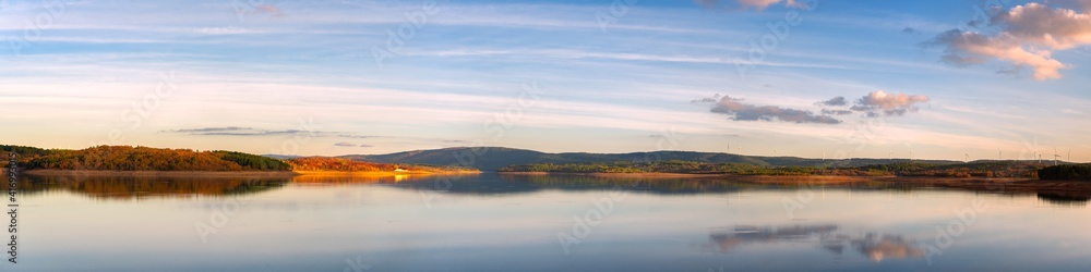 Panorama of a lake reservoir dam landscape view at sunset during autumn fall in Sabugal Dam, Portugal