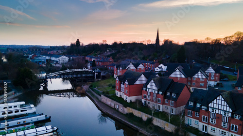 Northwich, Cheshire UK - February 27th 2021: Aerial view of  river Weaver flowing through Northwich Town Centre at Sunset.