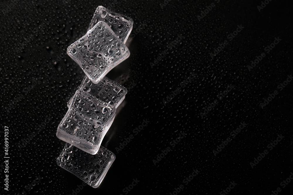 Ice cubes on black color texture. Concept art. Minimal surrealism. Flat lay with copy space. Soft focus. Ice cubes on black color texture. Concept art. Minimal surrealism. Flat lay with copy space. Soft focus.