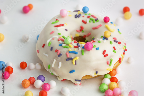 Delicious donut with icing and colorful decoration