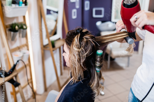Young woman enjoying in modern hairsalon. Beauty/fashion concept.