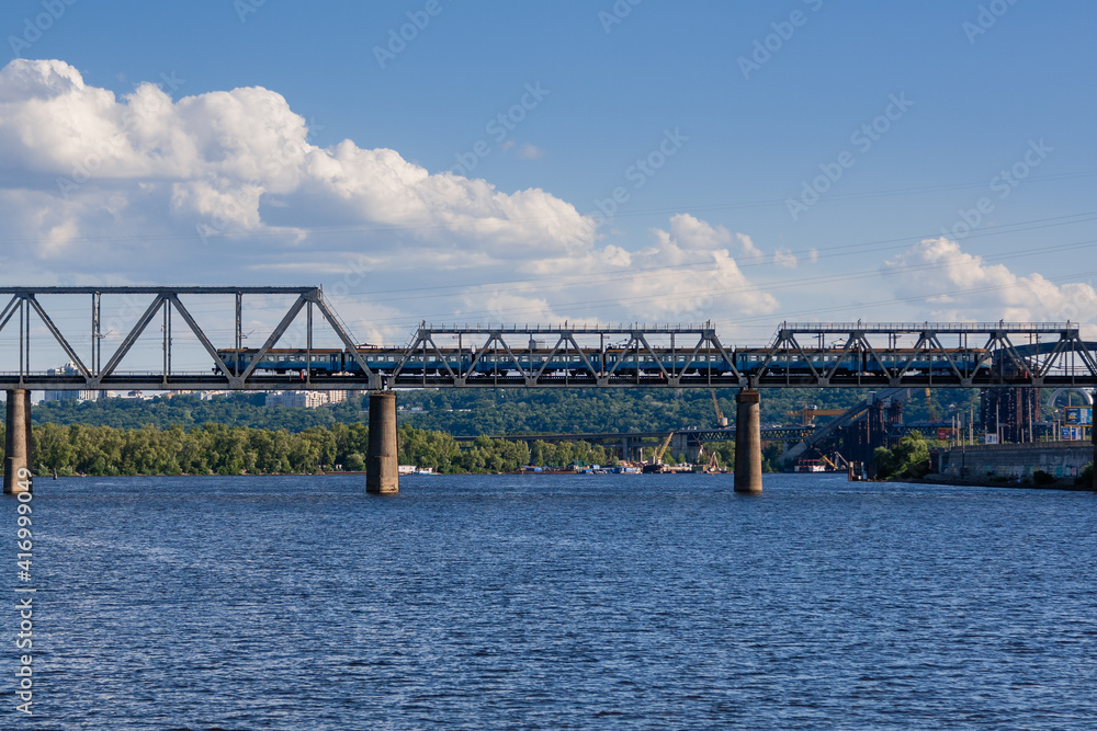 Railway bridge across the river on which the train is traveling