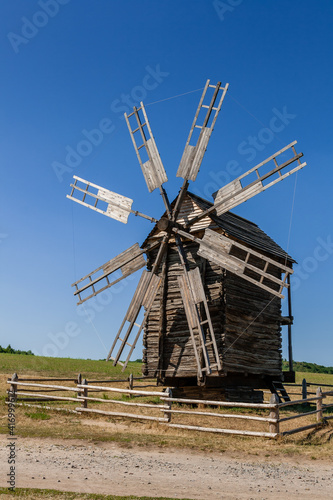 Old windmill on blue sky background