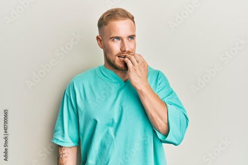 Young caucasian man wearing casual clothes looking stressed and nervous with hands on mouth biting nails. anxiety problem. © Krakenimages.com