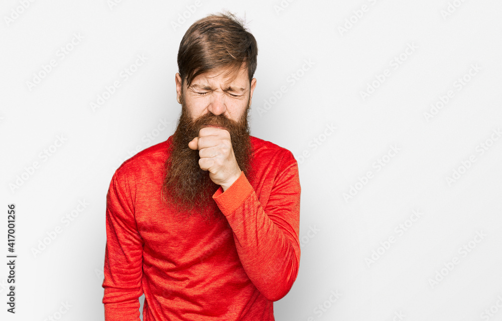 Redhead man with long beard wearing casual clothes feeling unwell and coughing as symptom for cold or bronchitis. health care concept. Redhead man with long beard wearing casual clothes feeling unwell and coughing as symptom for cold or bronchitis. health care concept.