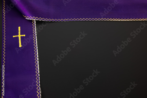 Fotografie Purple violet priest's stole on a black background