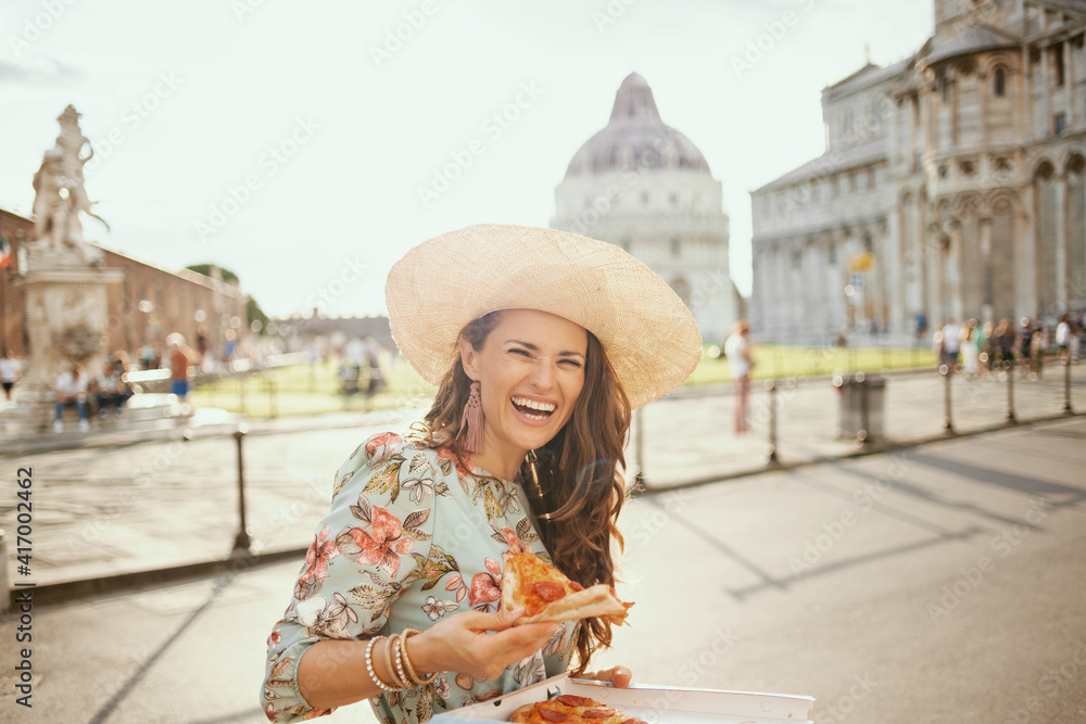 happy elegant woman in floral dress with pizza and hat