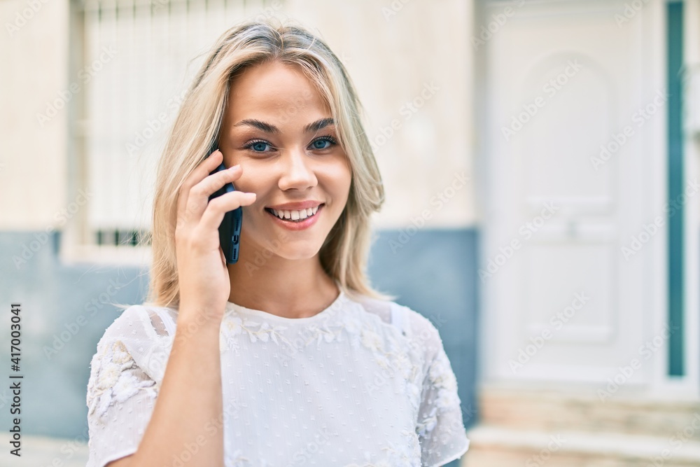 Young caucasian girl smiling happy using smartphone at street of city. Young caucasian girl smiling happy using smartphone at street of city.