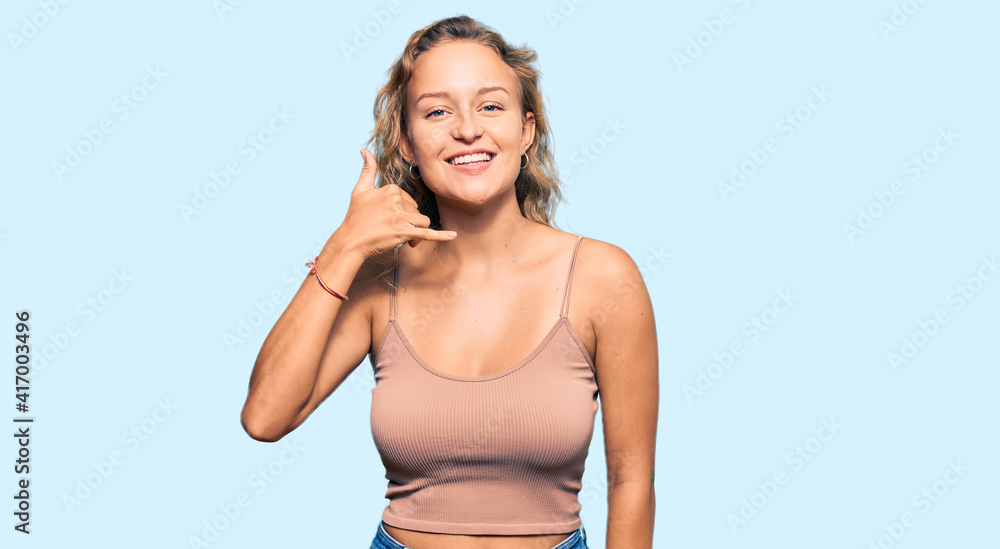 Fototapeta premium Beautiful caucasian woman wearing casual clothes smiling doing phone gesture with hand and fingers like talking on the telephone. communicating concepts.
