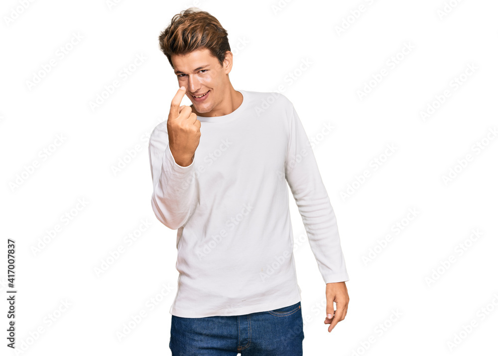 Handsome caucasian man wearing casual white sweater beckoning come here gesture with hand inviting welcoming happy and smiling Handsome caucasian man wearing casual white sweater beckoning come here gesture with hand inviting welcoming happy and smiling