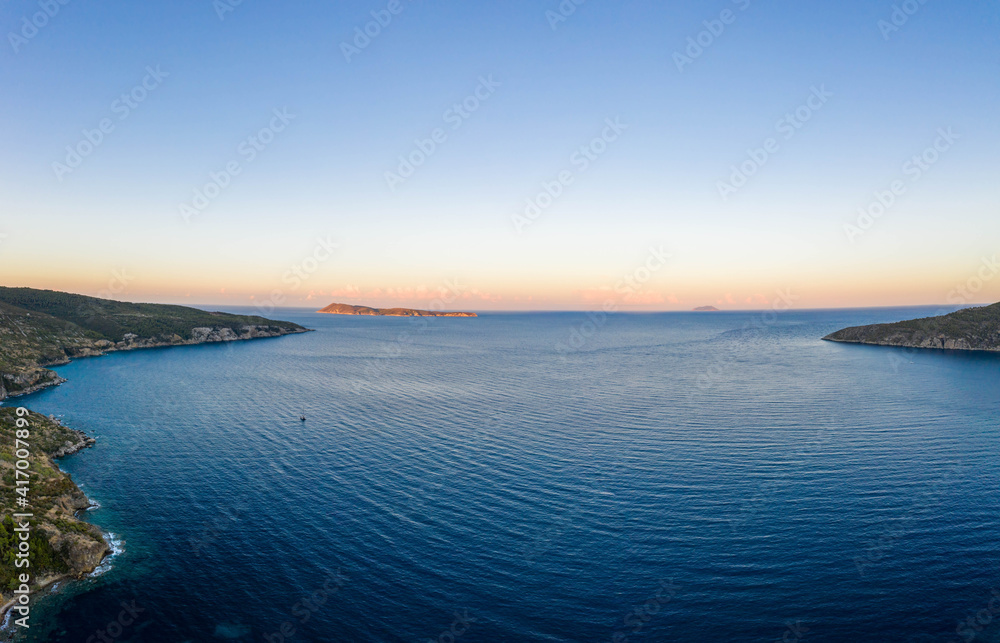 Aerial drone shot of Adriatic sea Bisevo island from Komiza Vis Island view in Croatia summer before sunrise